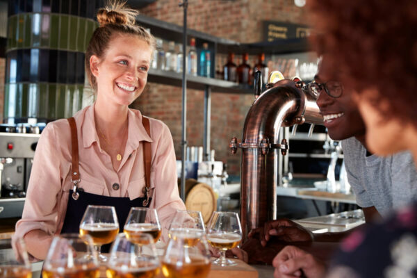 waitress serves beer at bar