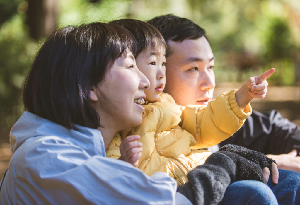 Happy and playful japanese family in a park in Tokyo