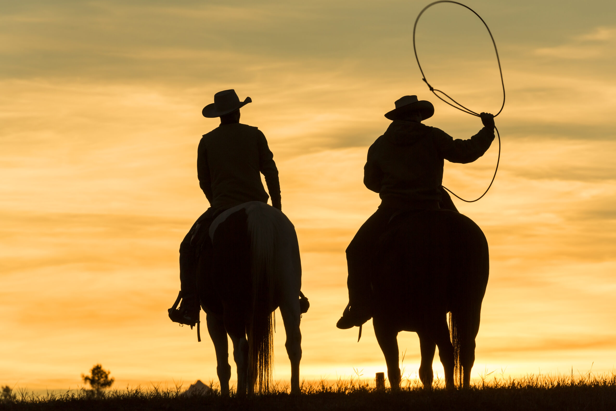 two-cowboys-riding-on-horseback